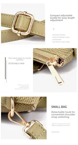Detail of adjustable strap buckle and smooth gold-tone zipper on bicolor tote bag