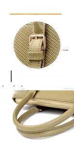 Detail of tan fabric tote with olive green handles and reinforced gold metal hardware