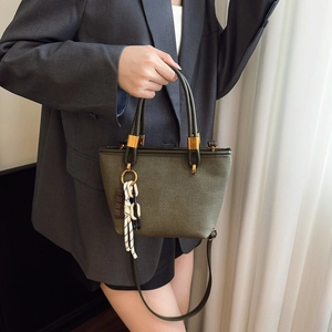 Minimalist military green canvas tote bag with round handles and adjustable strap