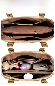 Detailed view of the handbag internal compartments showing spacious storage and golden zipper