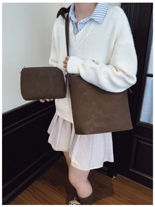 Brown matte bucket bag set styled with beige sweater and pleated skirt for daily commute