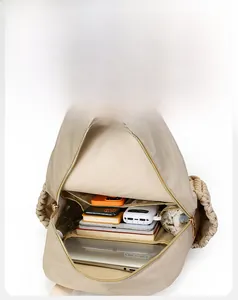 Internal view of large capacity beige backpack showing organized compartments and storage