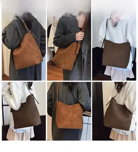 Multiple views of women's matte leather bucket bag paired with elegant autumn winter coats