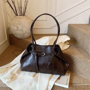 Vintage brown shoulder bag in glossy oil wax leather with minimalist buckle detail