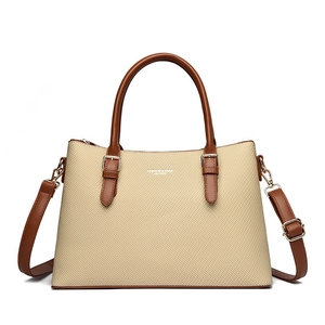 Retro cream woven tote bag with brown leather trim and adjustable shoulder strap
