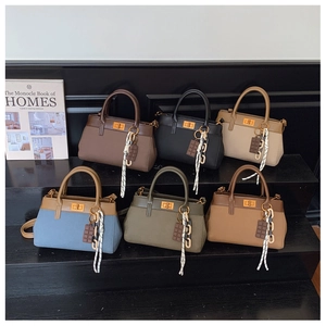 Detailed view of six vintage Boston bags in various colors with metallic twist locks
