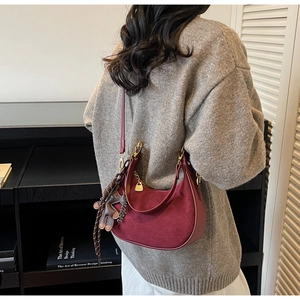 Burgundy suede crescent shoulder bag with London tag and gold hardware detail