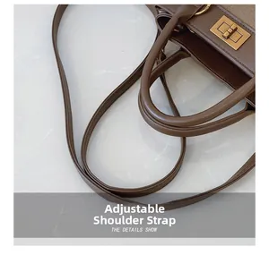 Detail of brown leather handbag with gold metal twist lock and adjustable shoulder strap