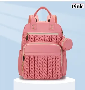 Detail of pink quilted fashion backpack with gold zipper and matching coin purse