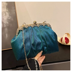 Detail of teal sequin evening bag featuring a gold floral clasp with diamond accents