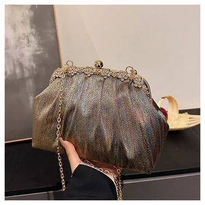 Detail of evening clutch with multi-color metallic fabric and floral crystal clasp