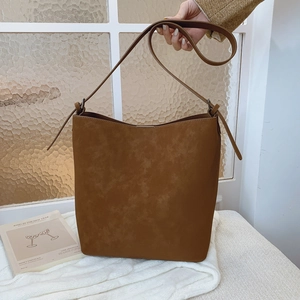 Elegant minimalist dark brown faux suede bucket bag with matching leather shoulder strap