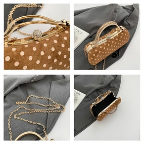 Detail of vintage polka dot handbag with gold metal clasp and detachable chain strap