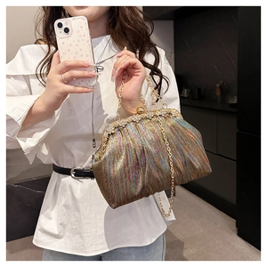 Close-up of sparkling iridescent sequin evening bag with elegant rhinestone clasp and chain