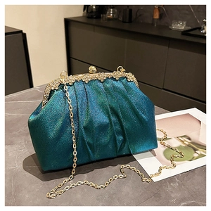 Detailed close-up of blue-green gradient glitter evening bag with floral diamond clasp