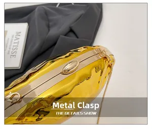 Detailed view of golden fluid ripple texture and metal lock on the elegant evening bag