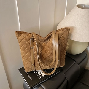 Brown quilted tote bag with silver studs and suede finish for commuting and fitness