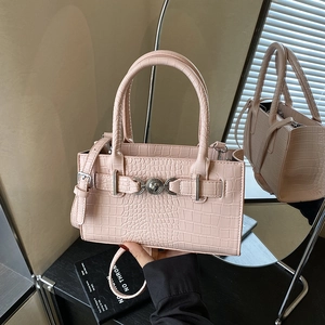Pink crocodile pattern handbag with lion head emblem and detachable shoulder strap