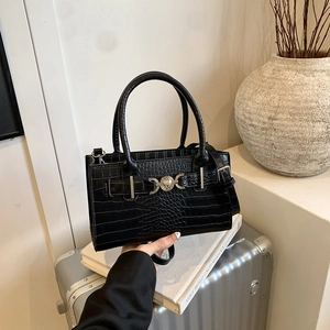 Chic black crocodile pattern handbag with silver clasp and adjustable shoulder strap