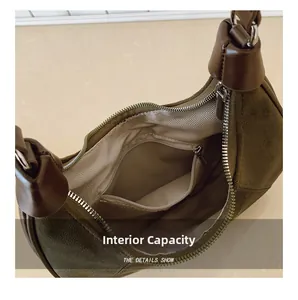 Close-up of the spacious brown suede crescent bag interior with herringbone lining