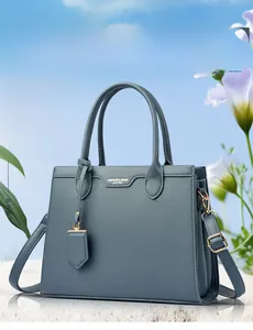 Close-up of litchi grain leather tote bag with metallic logo in a scenic outdoor setting