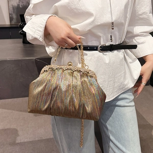 Elegant gold shimmer party handbag with rhinestone floral clasp and metal chain