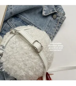 Detail showing the adjustable white leather shoulder strap and silver metal buckle on bag