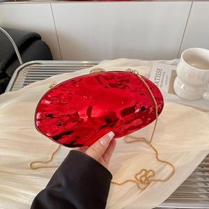 Modern oval red acrylic shell evening clutch with irregular ripples and gold chain strap