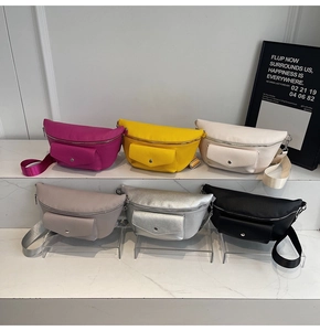 Detailed display of crescent fanny packs in six colors with textured leather finish