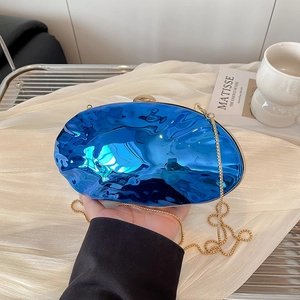 Blue acrylic egg-shaped shell clutch with wavy texture and gold chain strap