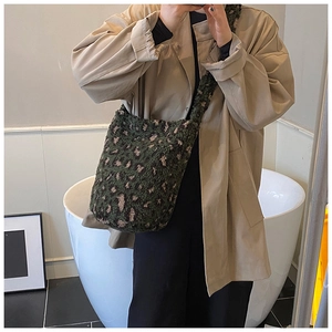 Detailed plush tote bag showing soft dark green leopard print faux fur texture