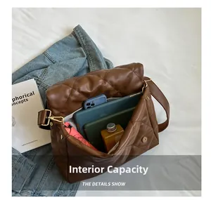 Spacious interior of a dark brown quilted tote bag showing capacity for iPad and essentials