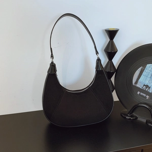 Retro black suede hobo bag with smooth leather trim and silver metal hardware accents