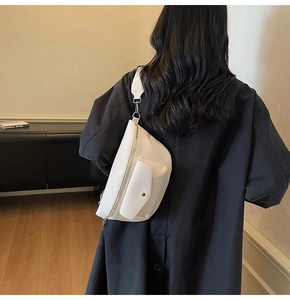 Rear view of a white lychee grain leather waist bag with wide strap and silver hardware