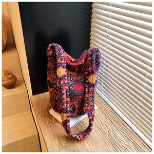 Detailed view of the colorful geometric pattern and plush fabric on the bucket bag
