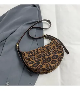 Detail shot of vintage leopard print crossbody bag with premium brown leather strap