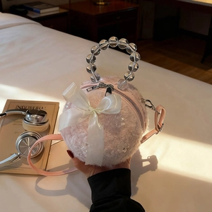 Chic pink faux fur spherical handbag with white bow and transparent beaded handle