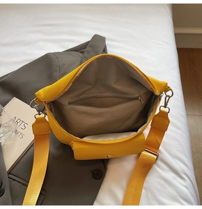 Detail of spacious interior with herringbone lining and zippered pocket in yellow fanny pack