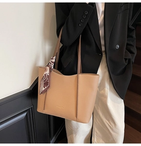 Chic light camel large tote bag with floral scarf handle detail on a fashion model