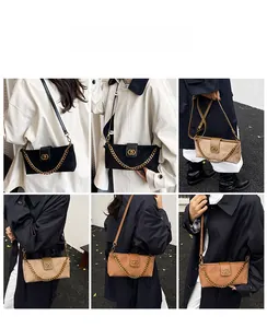 Close-up of diamond-quilted faux suede shoulder bag with gold chain and leather strap