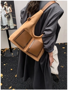 Détail de poches en cuir à rivets et texture en daim marron sur un sac cabas vintage