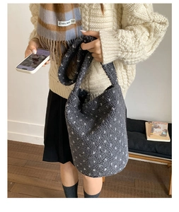 Close-up of soft grey faux fur tote bag with white polka dots for autumn winter fashion