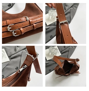 Dettaglio borsa sottobraccio in pelle scamosciata marrone con fibbie argentate e cuciture