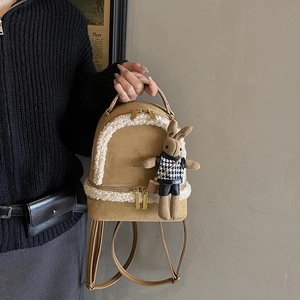 Light brown plush faux fur backpack with fleece trim and a cute rabbit doll pendant