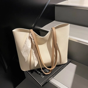 Minimalist cream white pebbled leather tote bag with brown straps and silk scarf detail