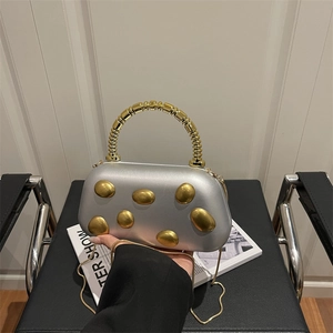 Chic silver underarm evening bag with gold pebble detail and beaded handle