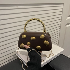 Brown leather underarm bag with gold oval metal ornaments and spiral hard handle