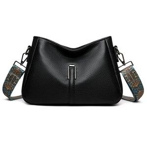 Chic black textured crossbody bag with a wide bohemian colorful shoulder strap