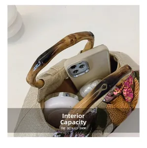 Top view detail of embroidered floral bag showing interior capacity with daily essentials