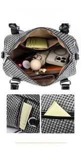 Macro view of houndstock pattern handbag showing interior compartments and zippers